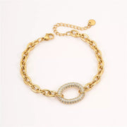 Gold-tone rhinestone chain bracelet displayed on white background