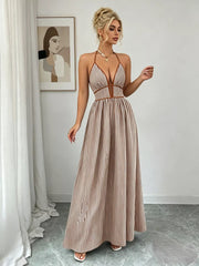 Khaki halter maxi dress shown from the front with full flowing skirt