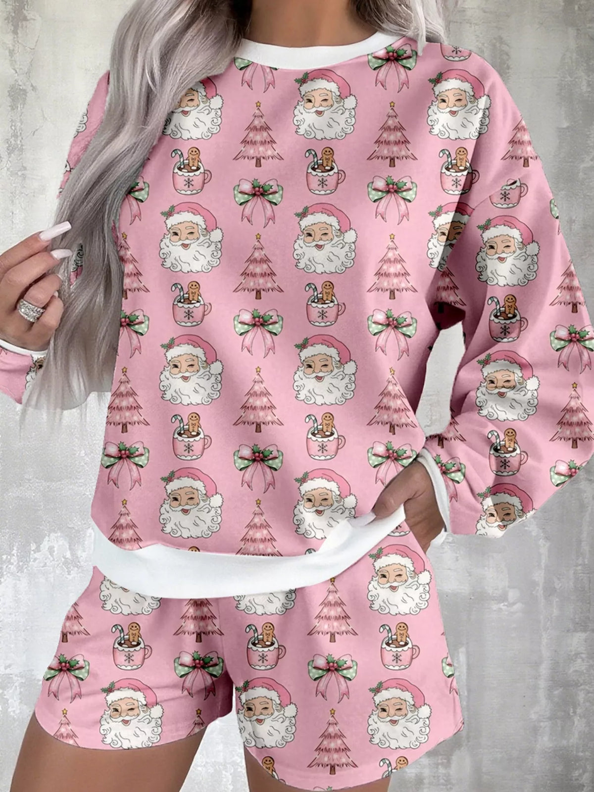 Women's Christmas Santa-Print Top & Shorts Lounge Set: Front view of pink long-sleeve top with repeating Santa faces and matching shorts.