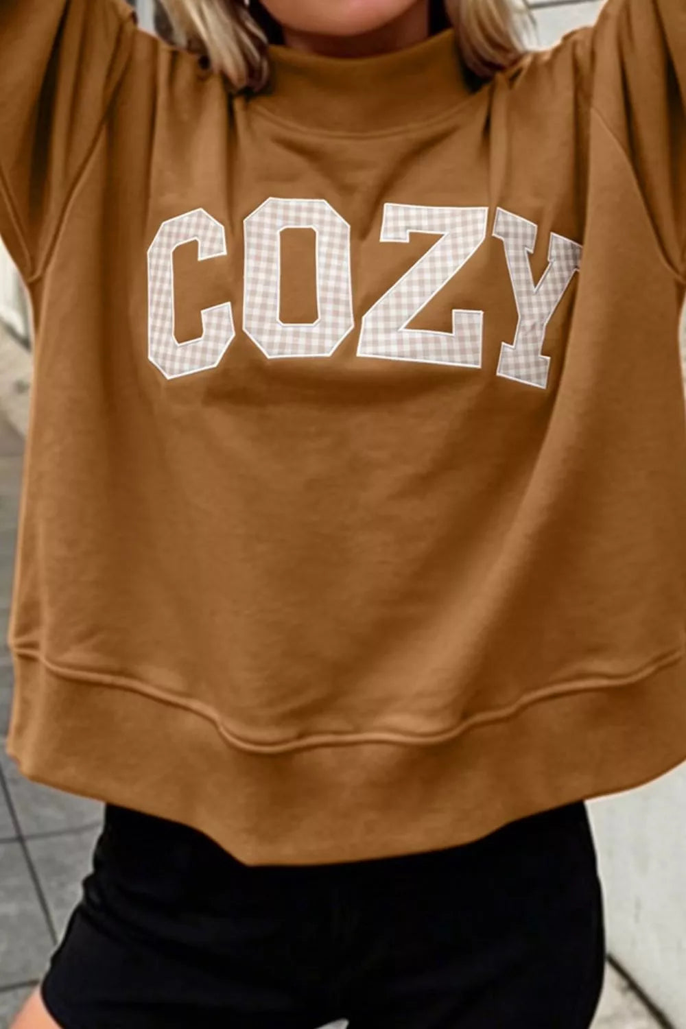 Close-up of COZY lettering and sweatshirt hem