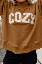 Close-up of COZY lettering and sweatshirt hem
