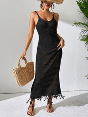 Front view of a black openwork cover-up dress with thin straps and a fringed hem