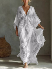 White and grey feather-print maxi dress with a tied V-neckline and loose sleeves, full front view.