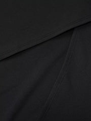 Detail view of the black maxi dress fabric and gathered seam.