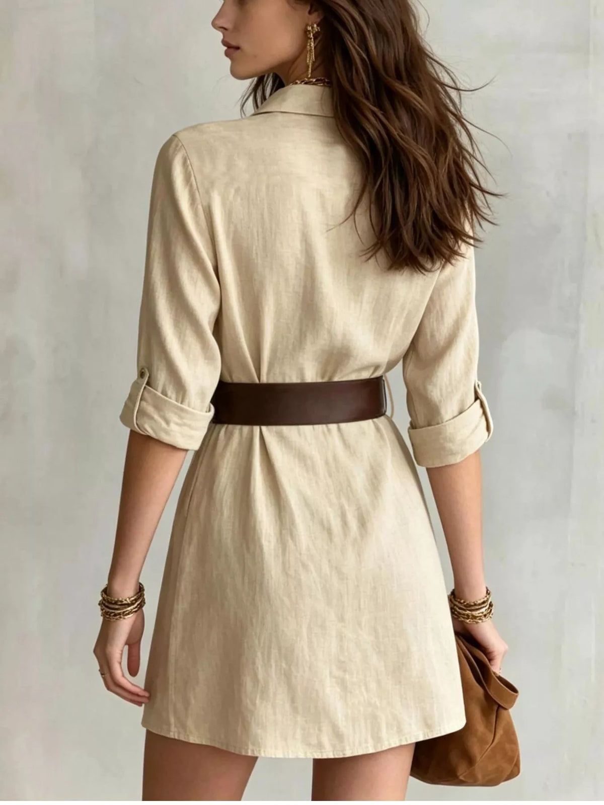 Back view of tan belted shirt dress with rolled sleeves