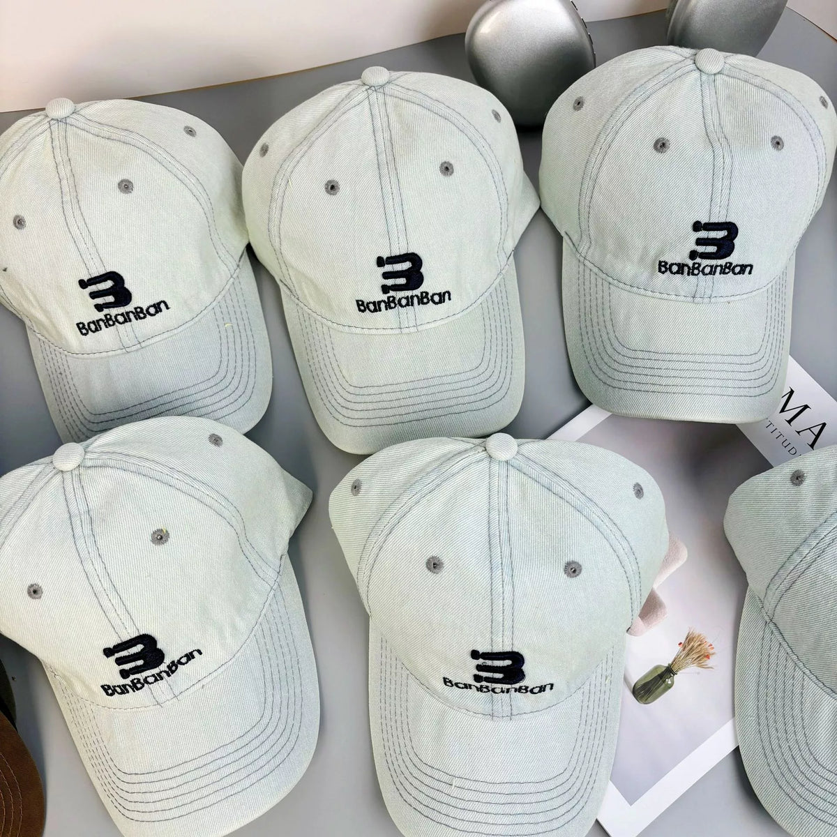 Light blue denim baseball cap shown from the front