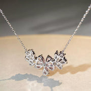 Close-up of silver-tone flower pendant necklace with clear stones