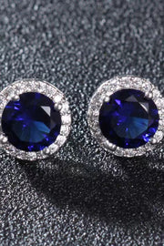 Contrast 2 Carat Moissanite Platinum-Plated Stud Earrings — Close-up of blue round moissanite studs on dark display