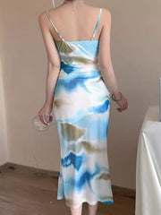 Back view of the blue and white watercolor midi dress showing its fitted shape and straps.