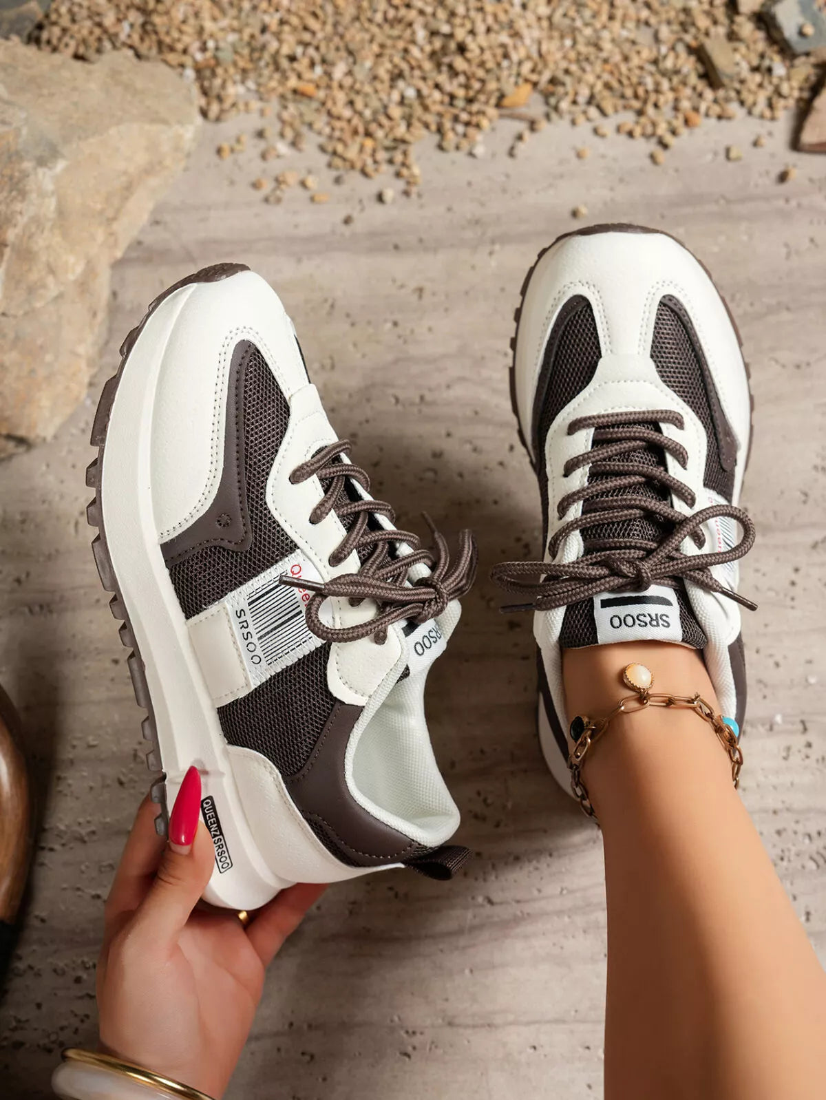 Pair of black and white lace-up sneakers viewed from above