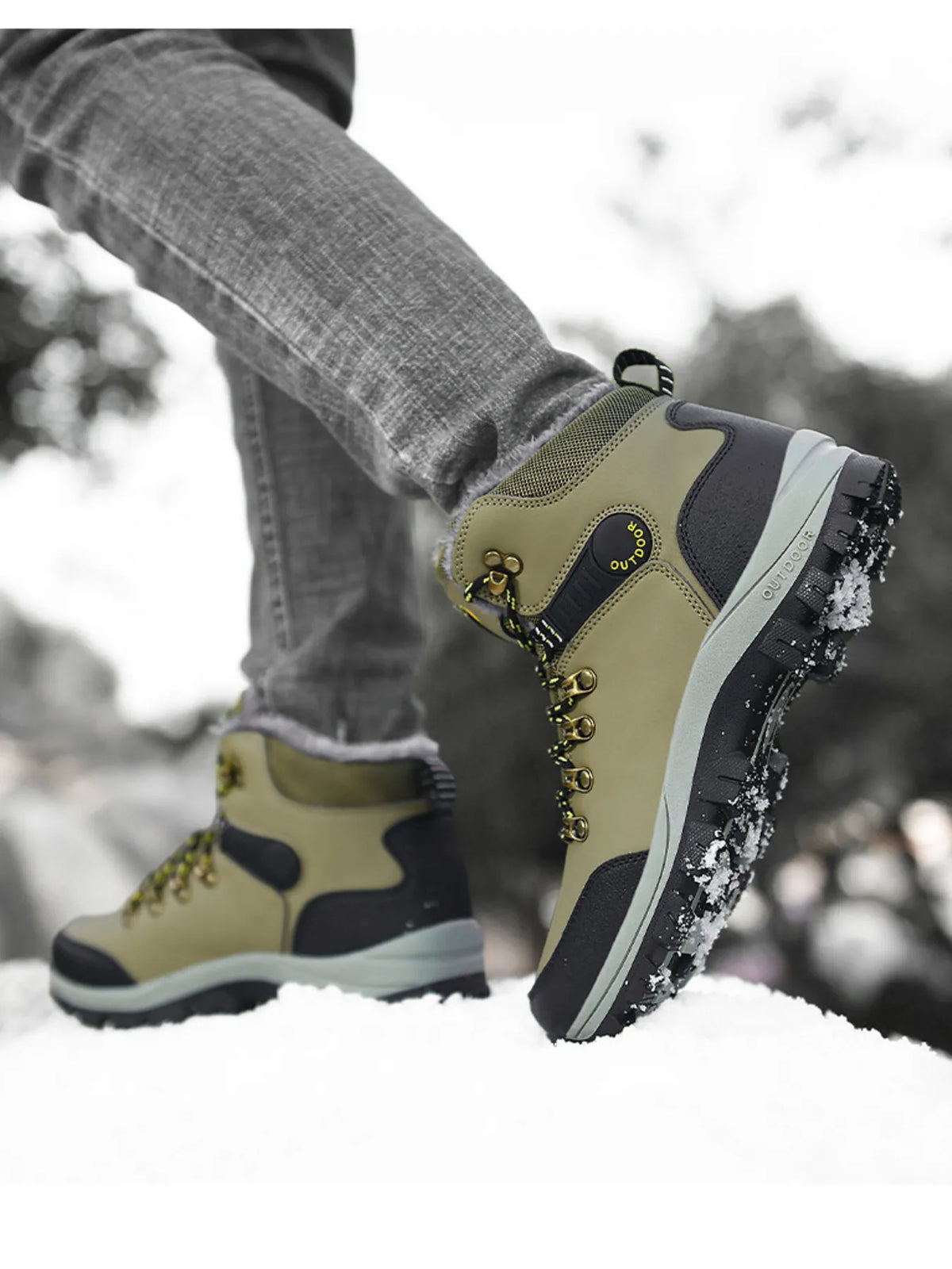 Side view of olive green lace-up boots showing black heel panels and treaded soles