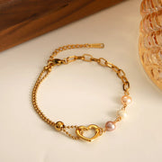 Gold heart pearl bracelet styled on a wrist