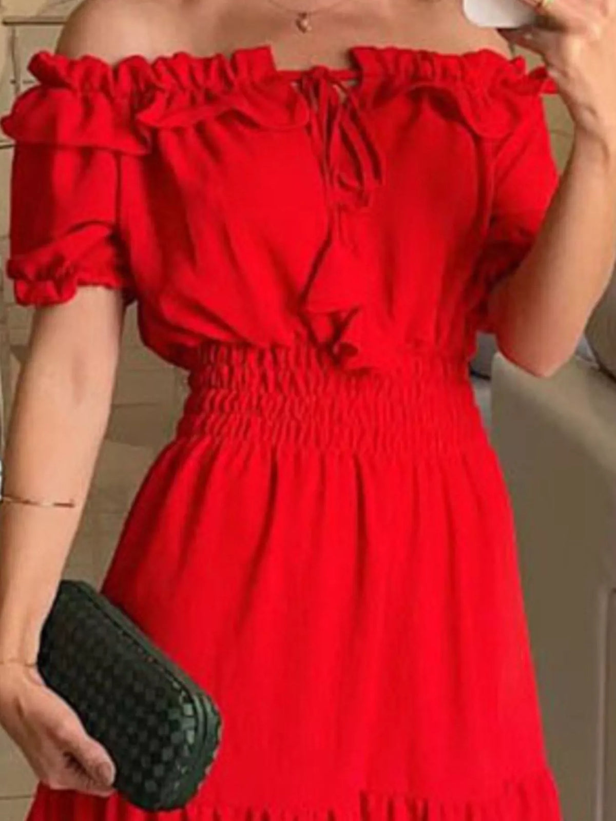Close-up of red off-shoulder ruffled neckline and smocked bodice