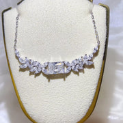 2 carat moissanite necklace with a floral cluster pendant on display