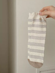Cream argyle mid-calf sock worn with sneakers