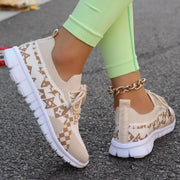 Cream patterned mesh sneaker, side view while worn
