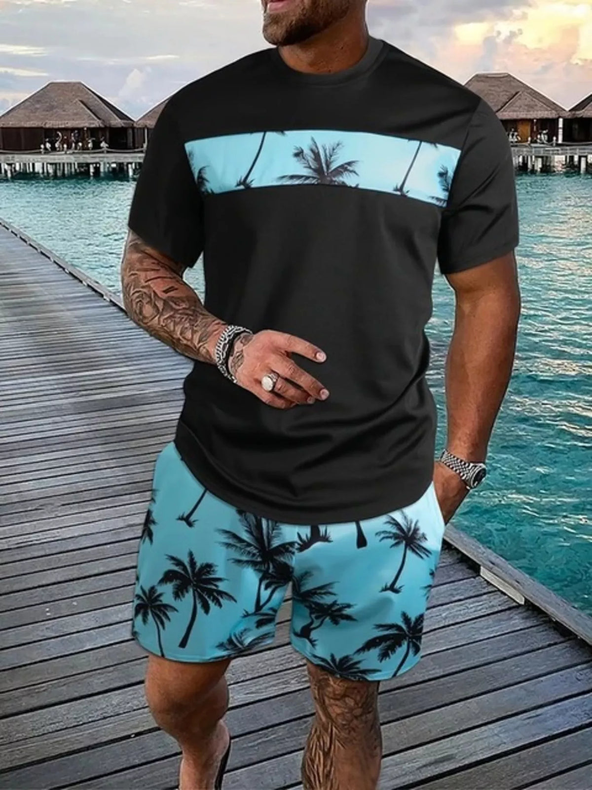 Black short-sleeve tee and shorts set with light blue panels and palm-tree print.