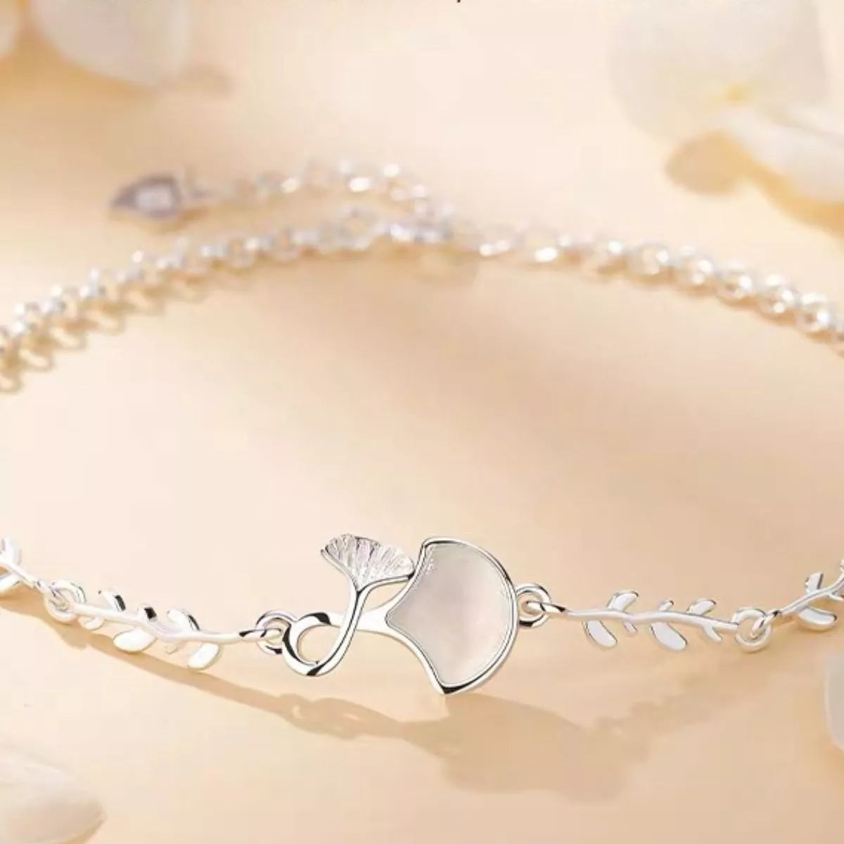 Close-up of the ginkgo leaf centerpiece on the silver bracelet