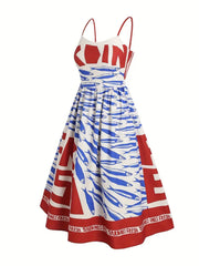 Front product view of a red, white and blue sardine-print midi dress with spaghetti straps.