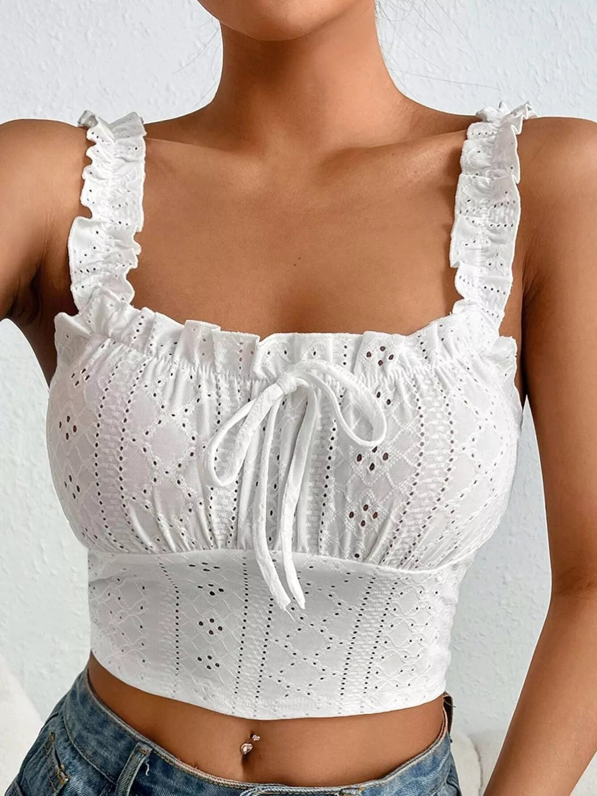 Close-up front view of white eyelet tie-front tank and ruffled straps