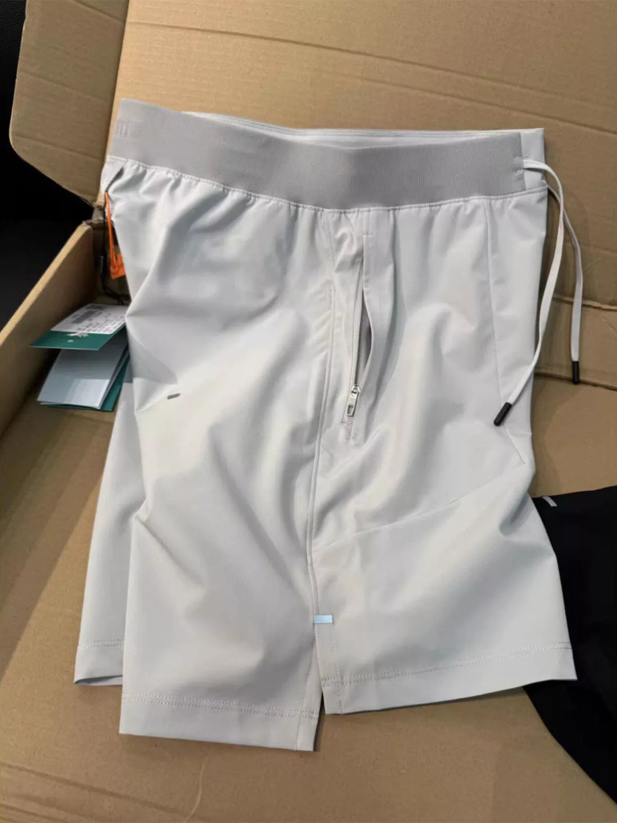 White lightweight athletic shorts laid flat