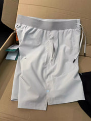 White lightweight athletic shorts laid flat