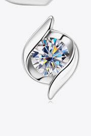 Close-up of round moissanite in curved silver-tone setting