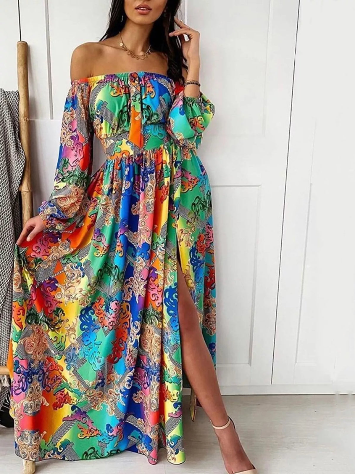Full-length view of the colorful blue multicolor off-shoulder maxi dress with a thigh-high slit.