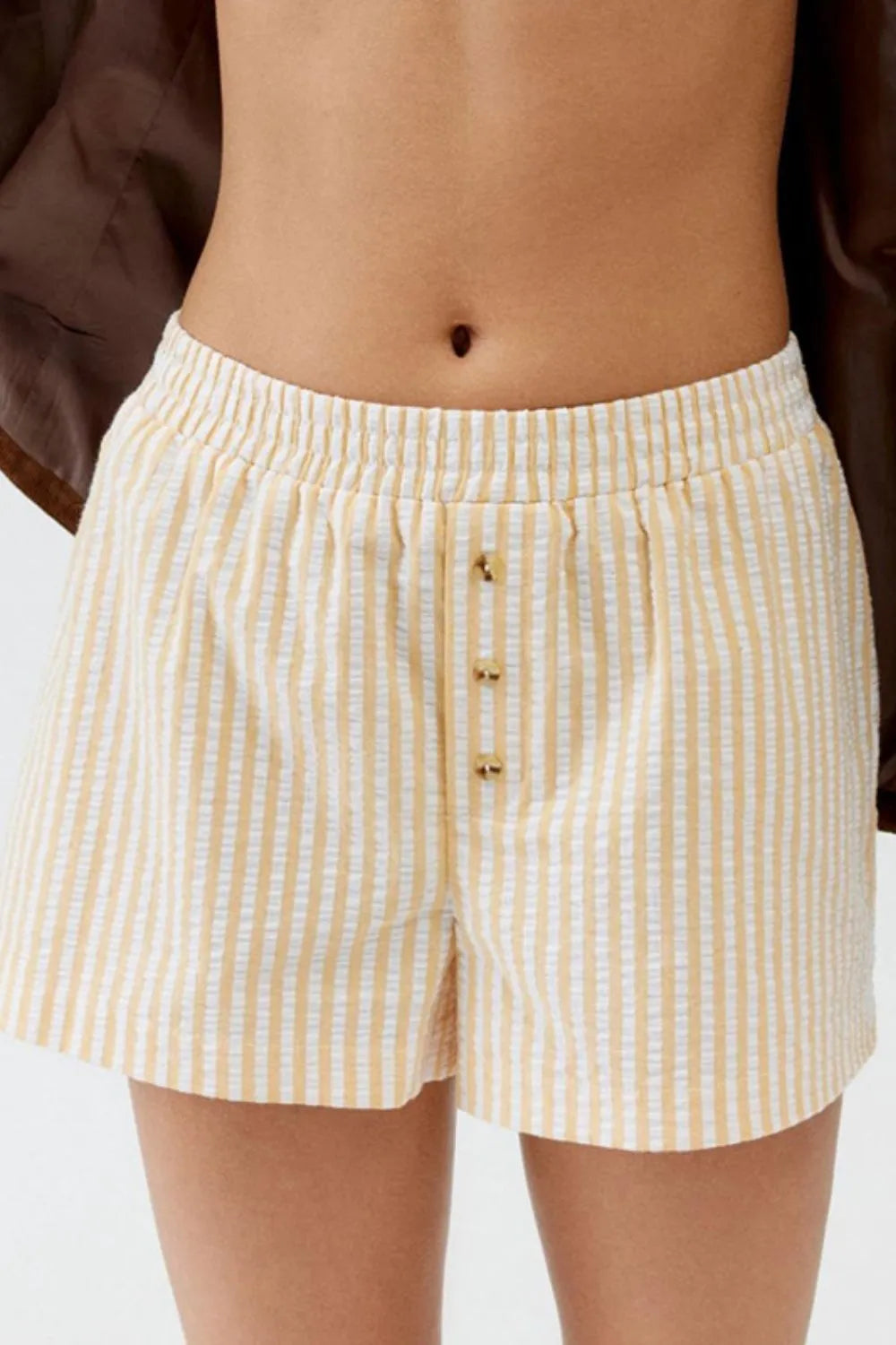 Cream striped shorts with elastic waist and front buttons