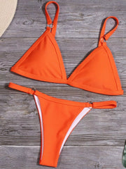 Women's solid-colour two-piece bikini set with ring detail, close-up