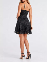 Back view of the black sequin mini dress showing adjustable straps and a straight back neckline.
