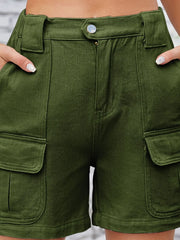 Close-up of olive cargo shorts showing button waist and pocket flap.
