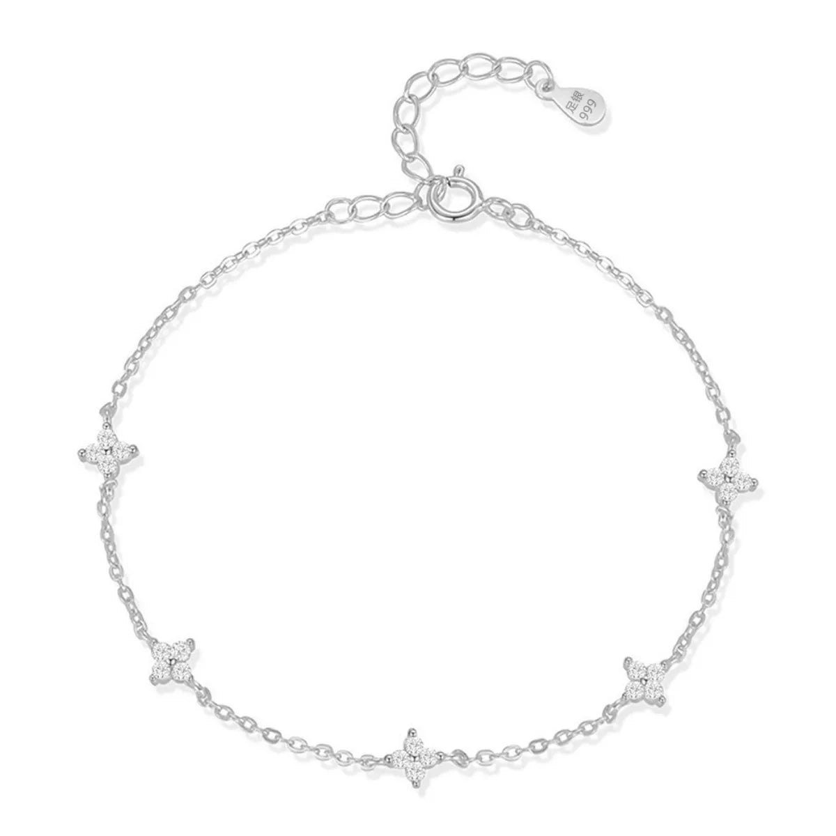 Silver-tone chain bracelet with star charms and an adjustable extender on white.