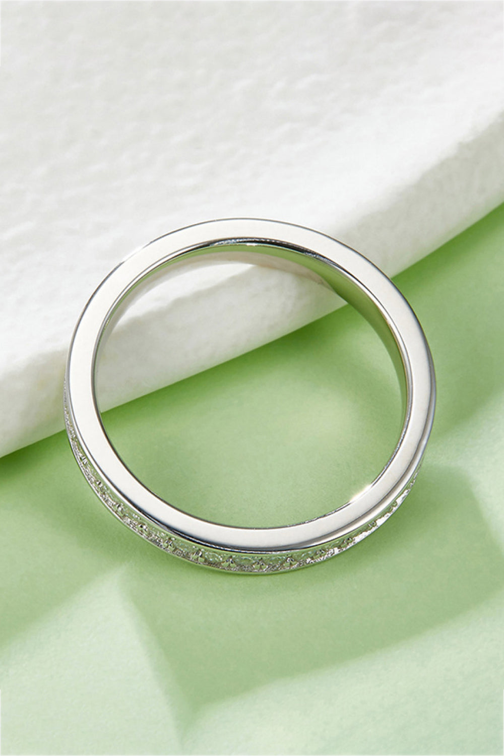 Back view of the plain band against pale green fabric.