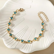 Gold-tone heart bracelet worn on wrist