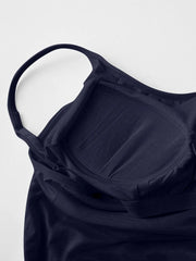 Close-up of dark navy cami dress's built-in bra cups and strap