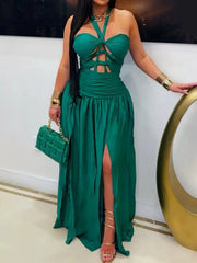 Model wearing dark-green cut-out halter maxi dress with thigh-high slit