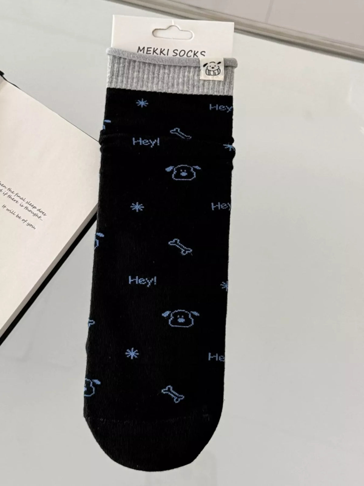 Black cartoon-print sock shown flat