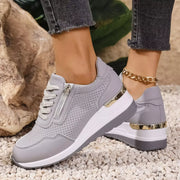 Pair of gray knit sneakers worn with cuffed jeans