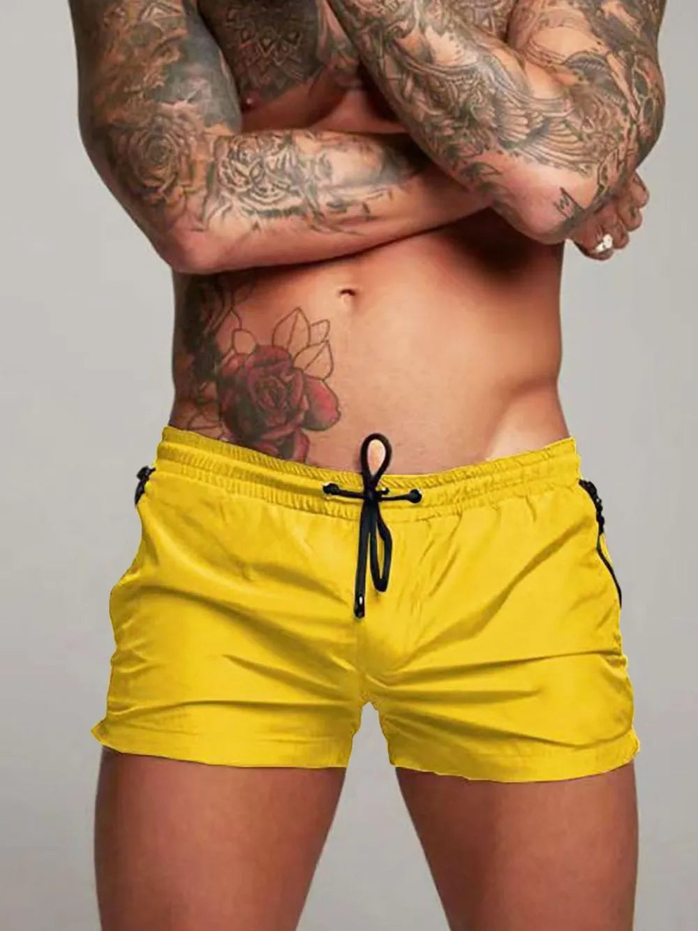 Model wearing yellow drawstring active shorts