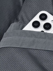 Close-up of jacket's mesh lining and internal pocket holding a mobile phone