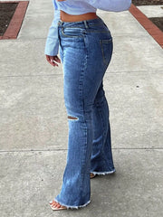Side view of dark blue ripped-knee flare jeans with a high waist and flared hem.