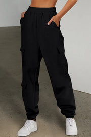 Model wearing black pocketed elastic-waist joggers with cuffed ankles