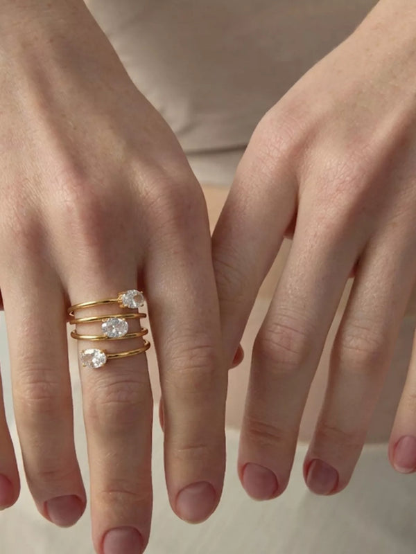 Triple-layer gold-tone open ring with oval clear stones