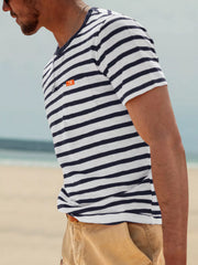 Side view of model wearing navy-and-white striped T-shirt