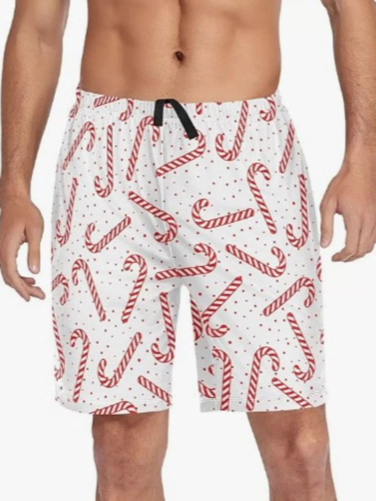 Model wearing white drawstring shorts printed with red striped candy canes and scattered dots