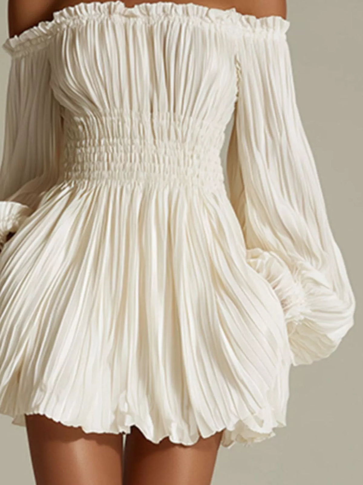 Closer view of the white pleats and gathered waist on the off-shoulder dress