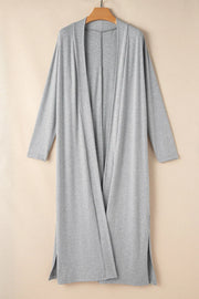 Gray long-sleeve cardigan hanging on a wooden hanger, back view