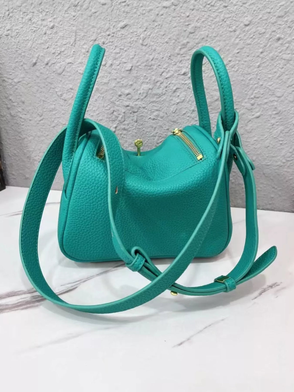 Teal crossbody bag from the back with long adjustable strap