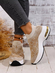 Beige patterned slip-on trainers shown from the side with contrasting white platform soles